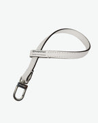 Packshot of a 1660L lanyard accessory to put on Hervé Chapelier bags and charms. The lanyard is made of leather in a small size. Lanière en cuir taille S à ajouter aux sacs et charms Hervé Chapelier