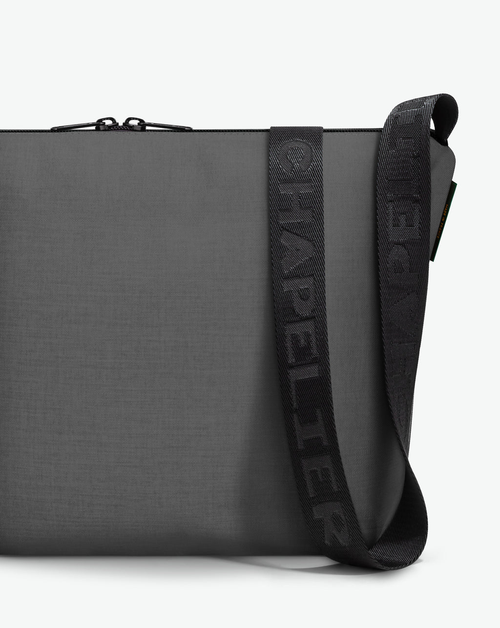 Packshot of a 1754CJQ shoulder crossbody bag with a large and long labeled “Chapelier” handle in polyamide The bag is made of solid polyamide, in a rectangular size Sac bandouliere epaule en nylon uni taille L