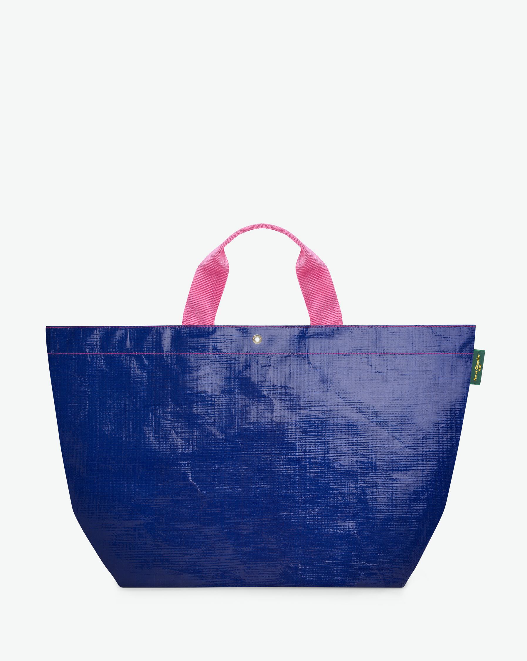 Sac cabas marché coloré en polypropylène, à fond rectangulaire et dans une taille L, aux poignées courtes de couleur en polyamide et à l'œillet décoratif.