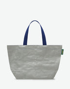 Sac cabas marché coloré en polypropylène, à fond rectangulaire et dans une taille L, aux poignées longues de couleur en polyamide et à l'œillet décoratif. Idéal pour un porté à l'épaule.