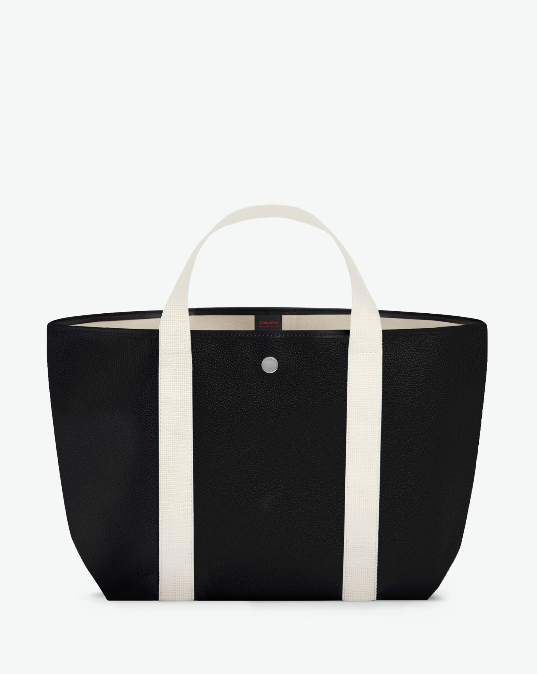 Sac à main en toile enduite grainée, à fond rectangulaire et dans une taille M, et aux poignées courtes de couleur à l'aspect coton faisant le tour du sac.