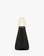 Sac à main en toile enduite grainée, à fond rectangulaire et dans une taille M, et aux poignées courtes de couleur à l'aspect coton faisant le tour du sac.