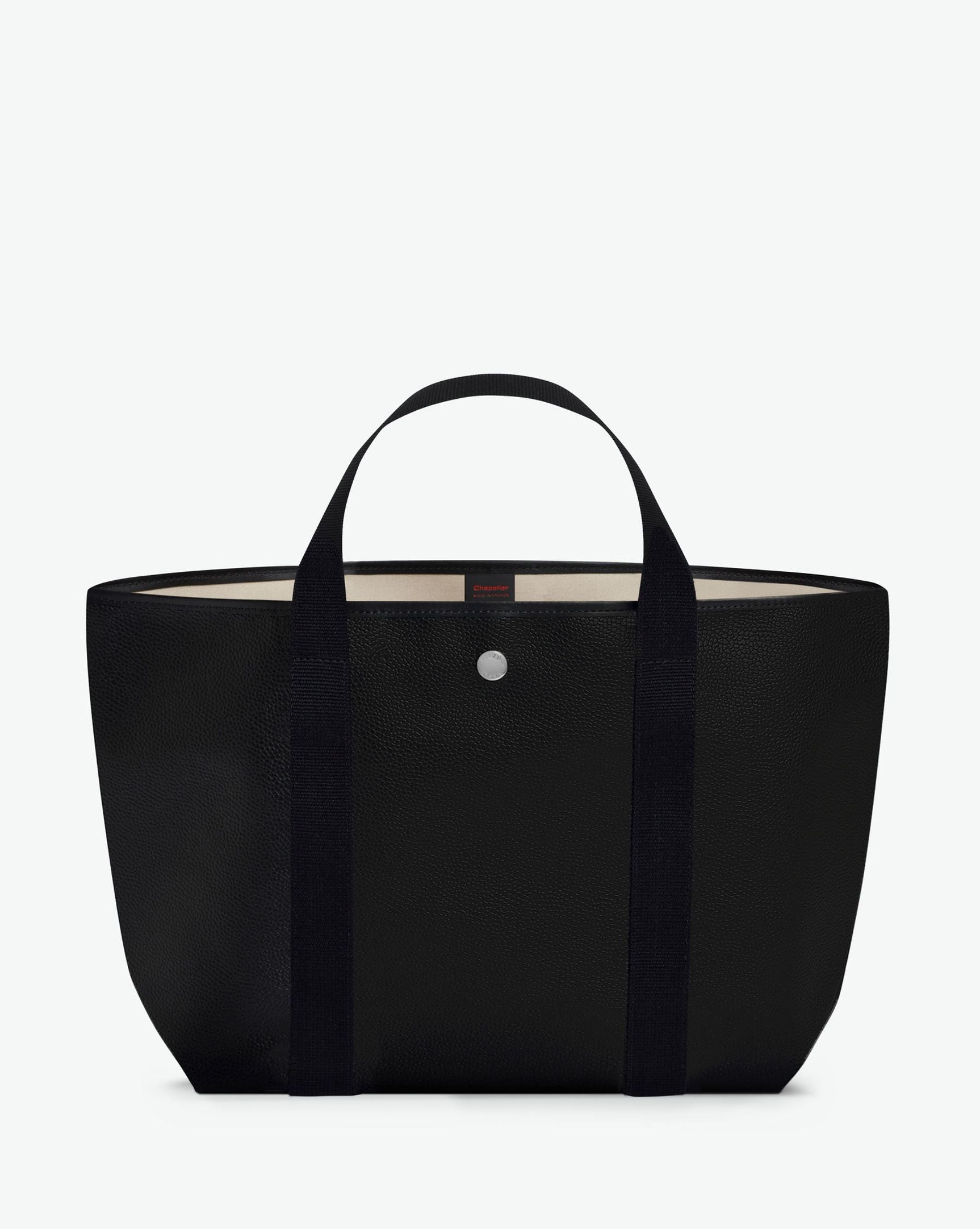 Sac à main en toile enduite grainée, à fond rectangulaire et dans une taille M, et aux poignées courtes de couleur à l'aspect coton faisant le tour du sac.