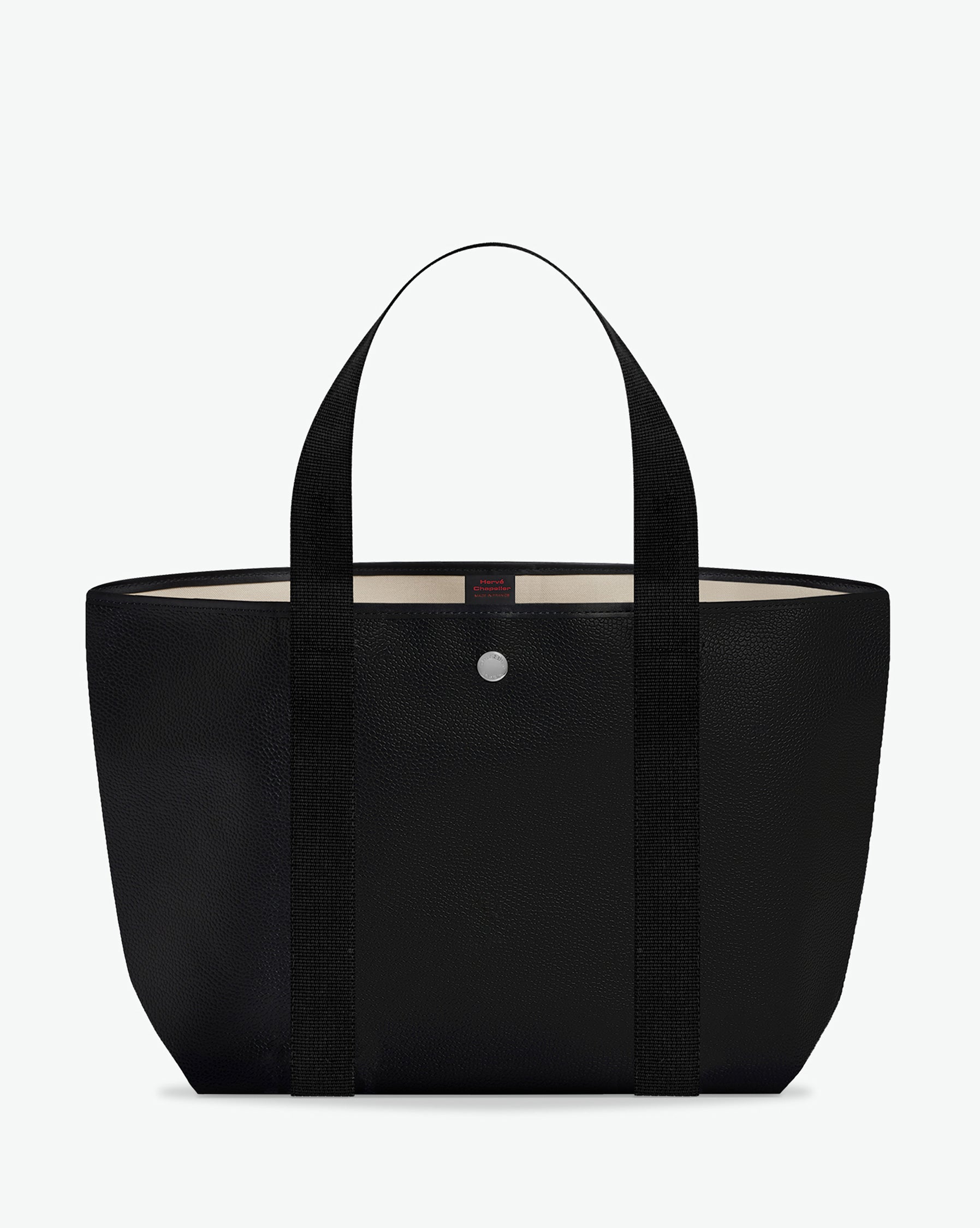 Sac porté épaule en toile enduite grainée, à fond rectangulaire et dans une taille M, et aux poignées longues de couleur à l'aspect coton faisant le tour du sac.