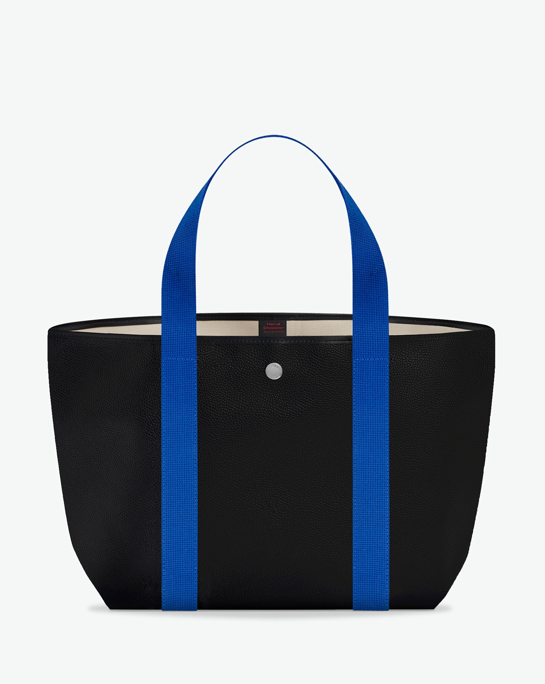 Sac porté épaule en toile enduite grainée, à fond rectangulaire et dans une taille M, et aux poignées longues de couleur à l'aspect coton faisant le tour du sac.