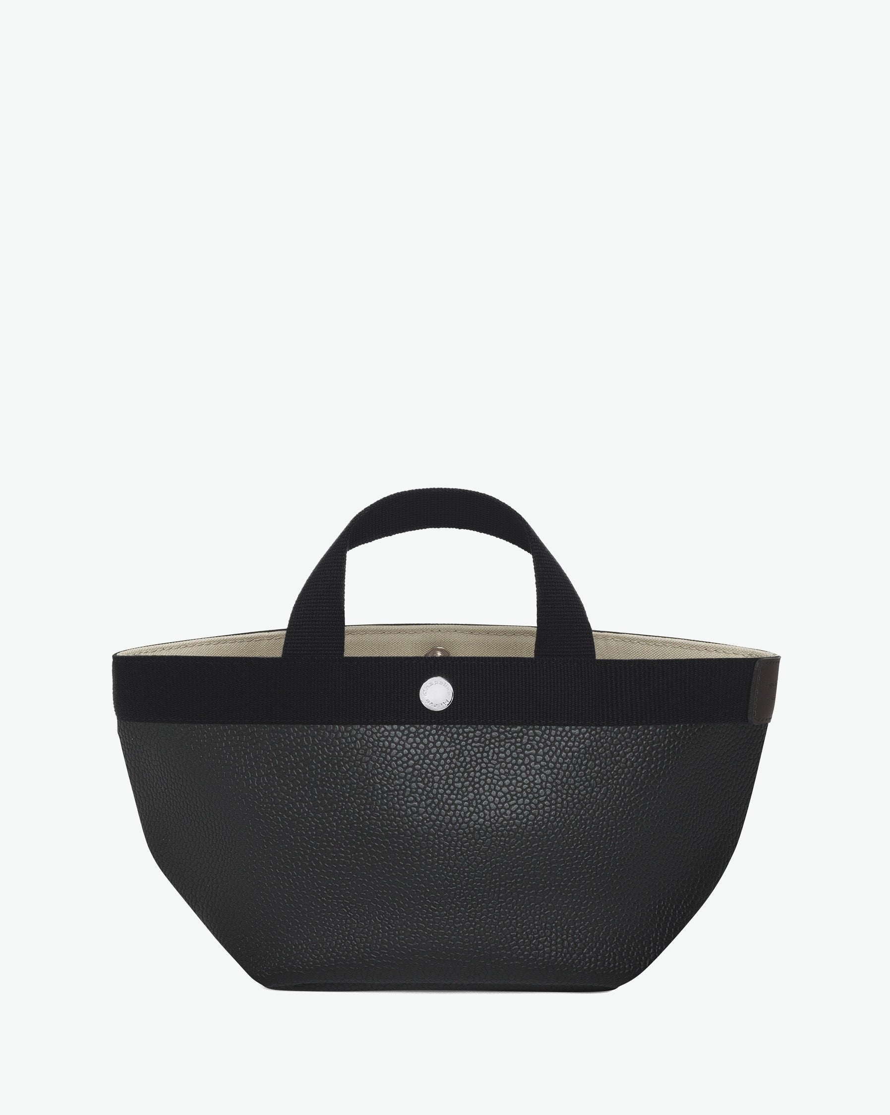 Sac à main en toile enduite grainée en taille S, au fond carré et aux poignées courtes de couleur à l'aspect coton, ainsi qu'à la poche intérieure avec bouton pression.