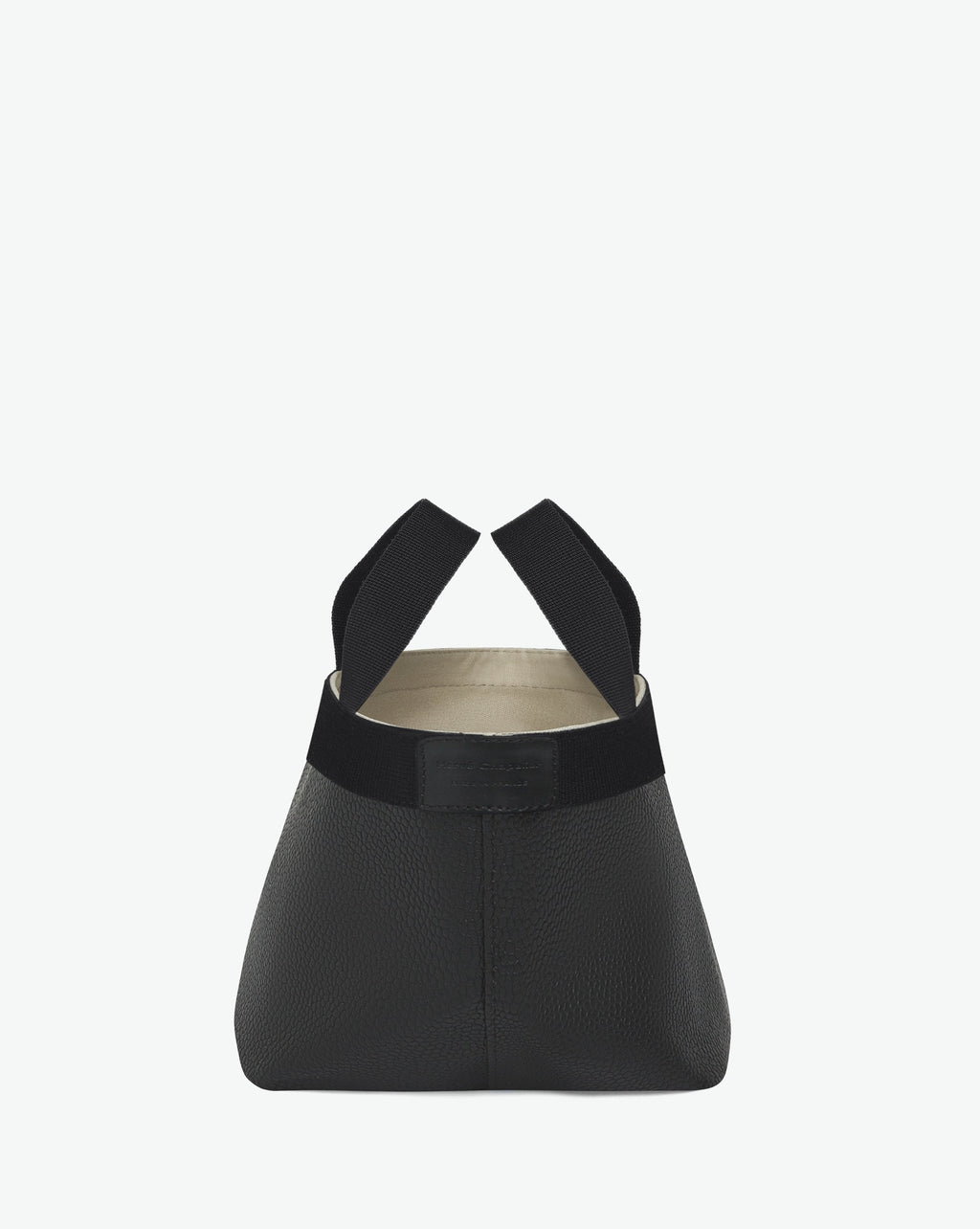Sac à main en toile enduite grainée en taille S, au fond carré et aux poignées courtes de couleur à l'aspect coton, ainsi qu'à la poche intérieure avec bouton pression.
