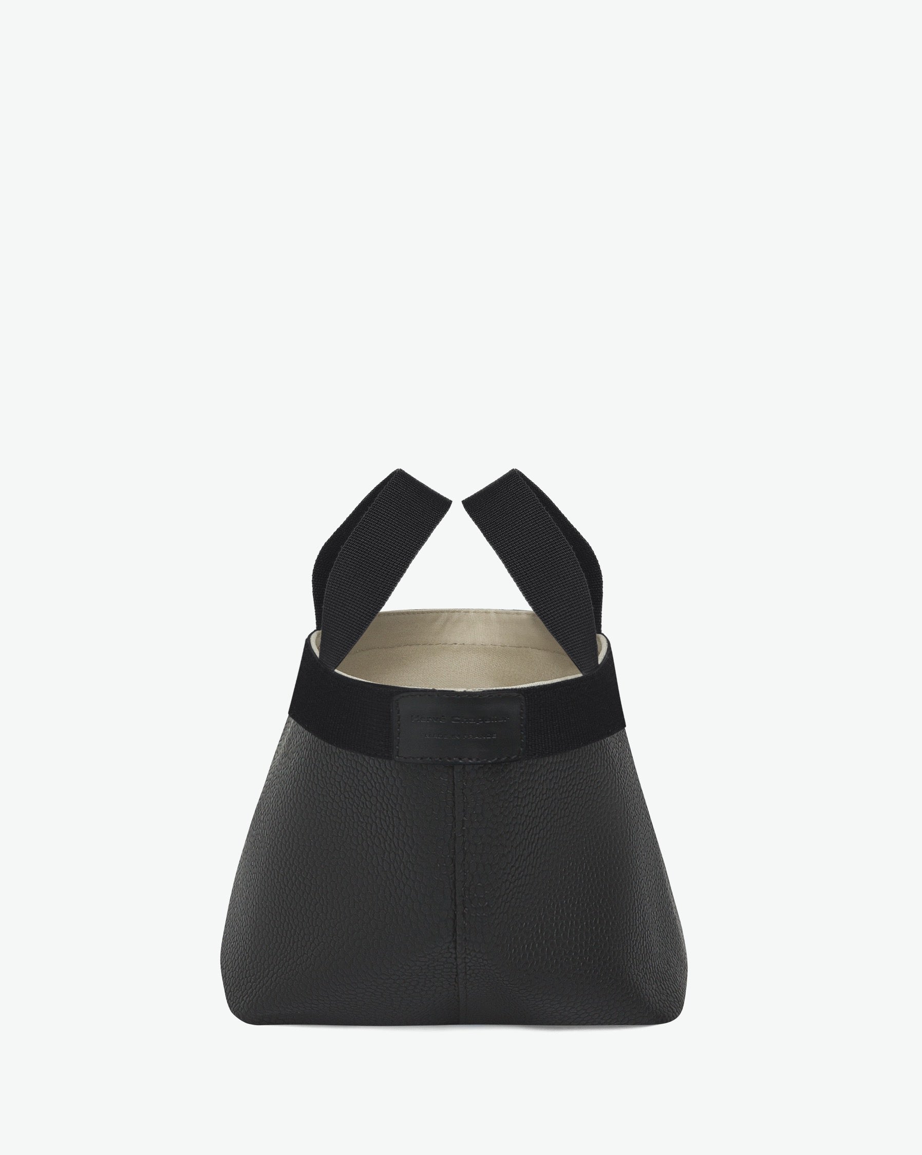 Sac à main en toile enduite grainée en taille S, au fond carré et aux poignées courtes de couleur à l'aspect coton, ainsi qu'à la poche intérieure avec bouton pression.