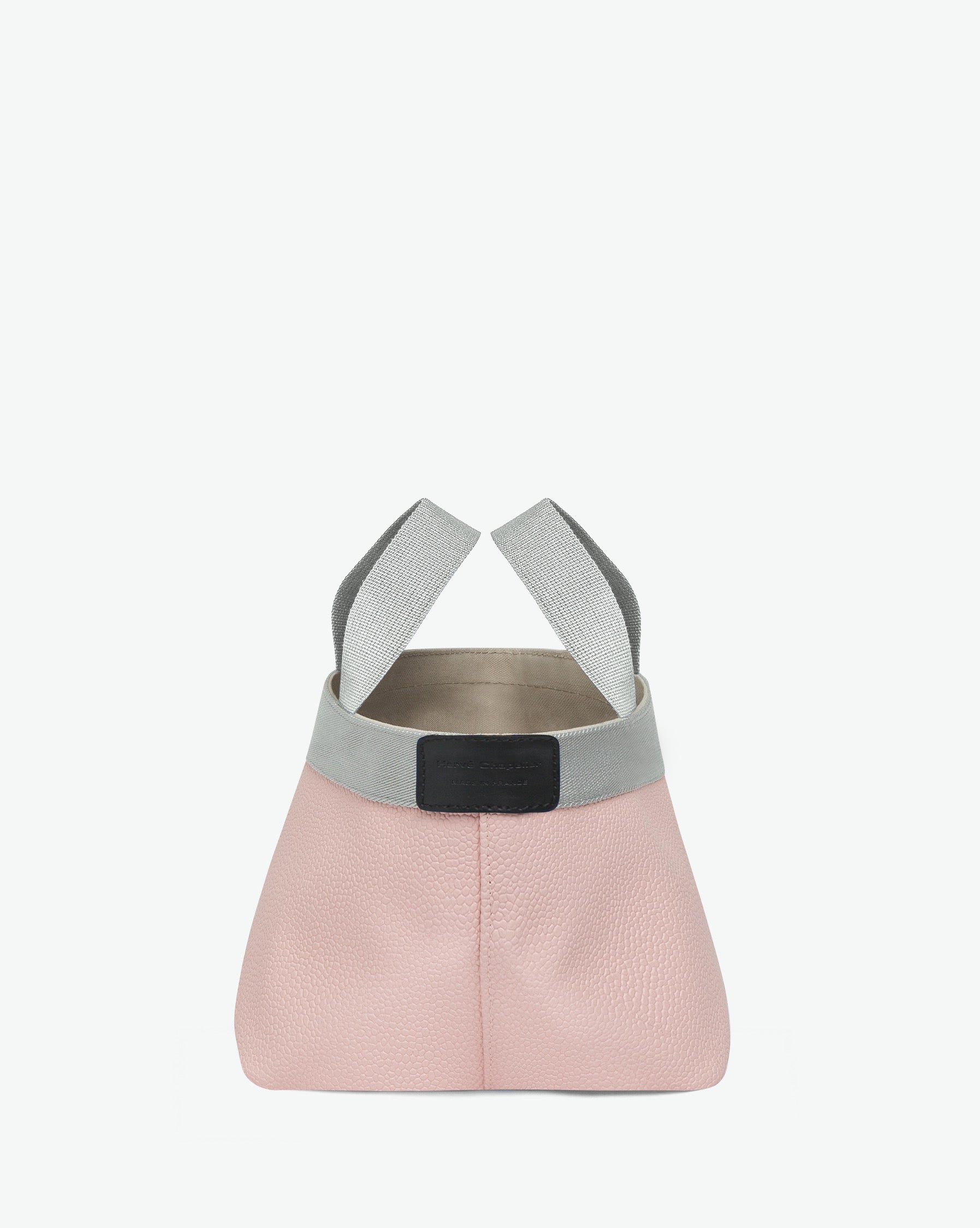 Sac à main en toile enduite grainée en taille S, au fond carré et aux poignées courtes de couleur à l'aspect coton, ainsi qu'à la poche intérieure avec bouton pression.