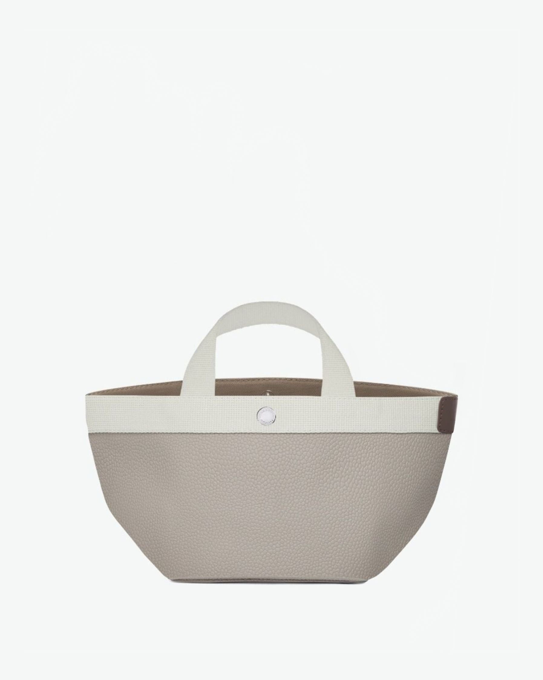 Sac à main en toile enduite grainée en taille S, au fond carré et aux poignées courtes de couleur à l'aspect coton, ainsi qu'à la poche intérieure avec bouton pression.