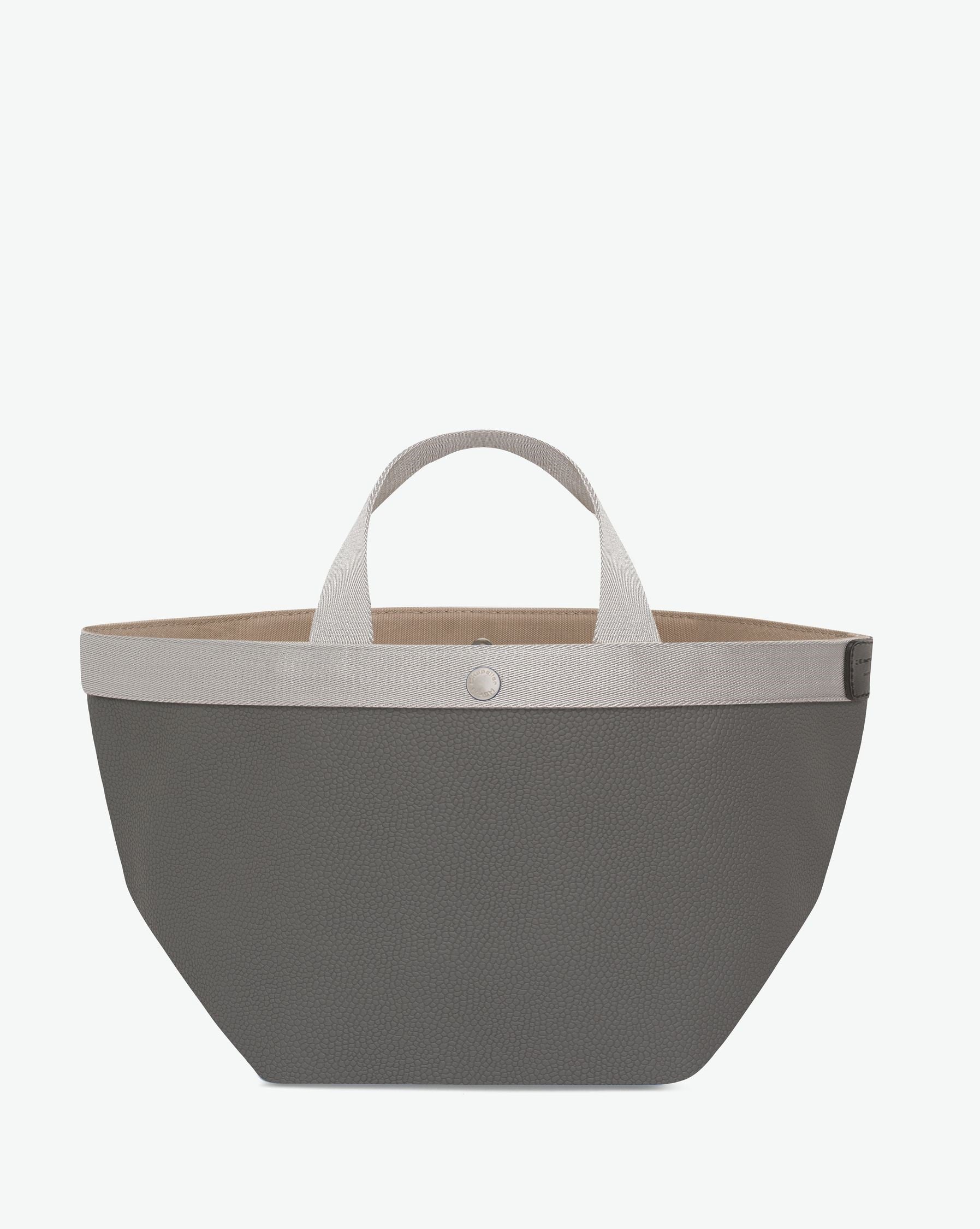 Sac à main en toile enduite grainée en taille M, au fond carré et aux poignées courtes de couleur à l'aspect coton, ainsi qu'à la poche intérieure avec bouton pression.
