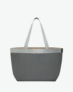 Sac à main en toile enduite grainée en taille L, au fond rectangulaire et aux poignées longues de couleur à l'aspect coton, ainsi qu'à la poche intérieure avec bouton pression.