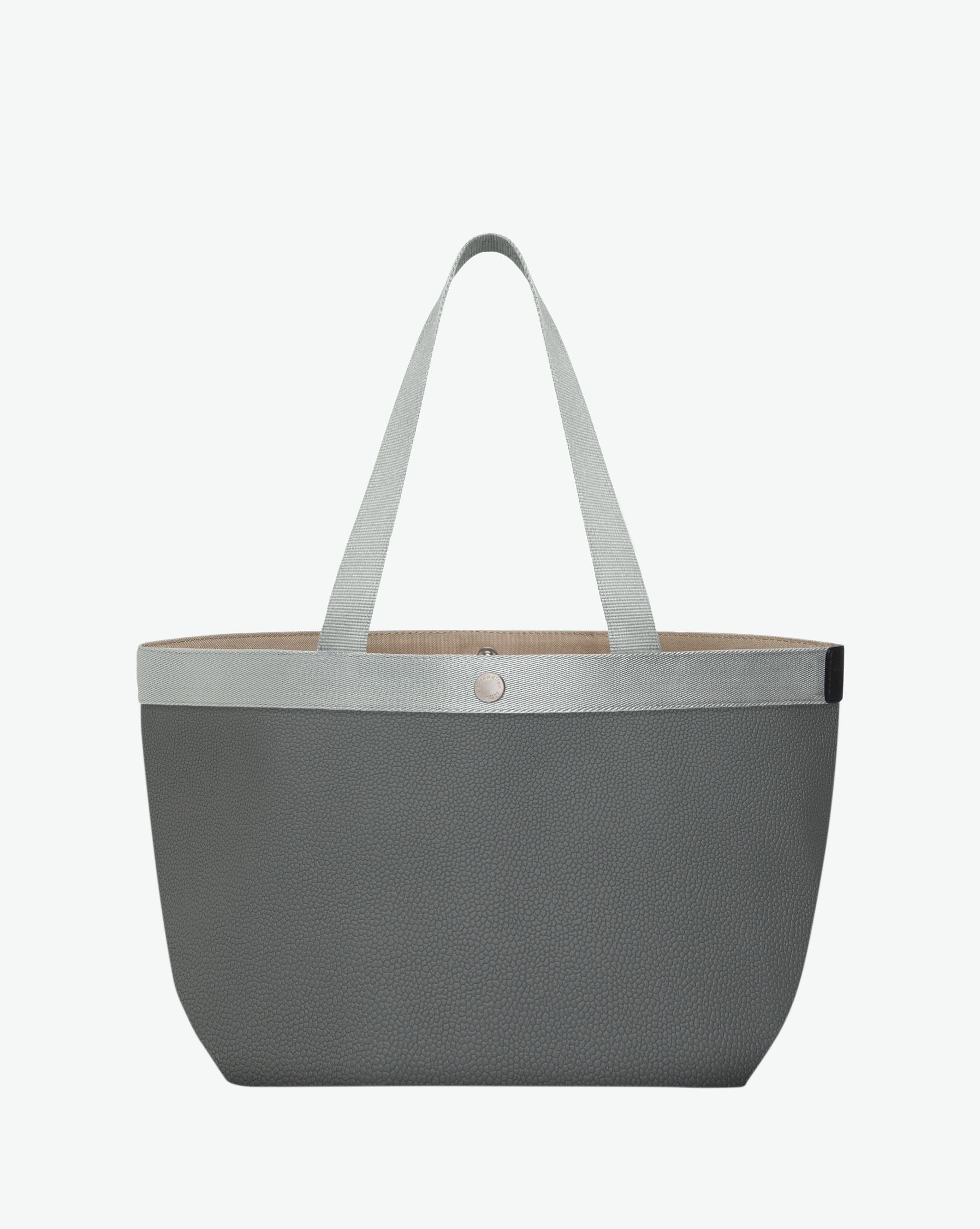 Sac à main en toile enduite grainée en taille L, au fond rectangulaire et aux poignées longues de couleur à l'aspect coton, ainsi qu'à la poche intérieure avec bouton pression.