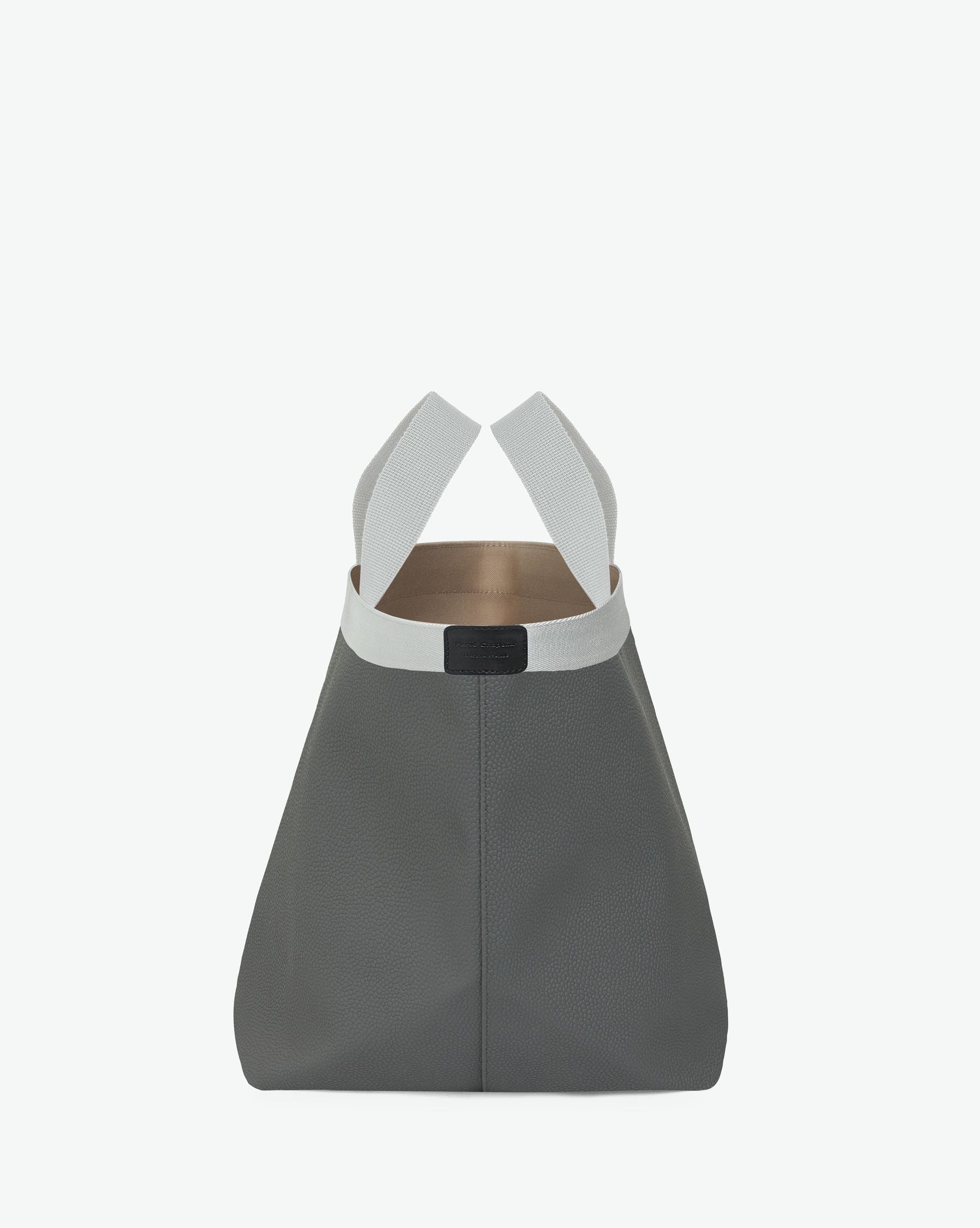 Sac à main en toile enduite grainée en taille L, au fond carré et aux poignées longues de couleur à l'aspect coton, ainsi qu'à la poche intérieure avec bouton pression.