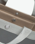 Sac à main en toile enduite grainée en taille L, au fond carré et aux poignées longues de couleur à l'aspect coton, ainsi qu'à la poche intérieure avec bouton pression.