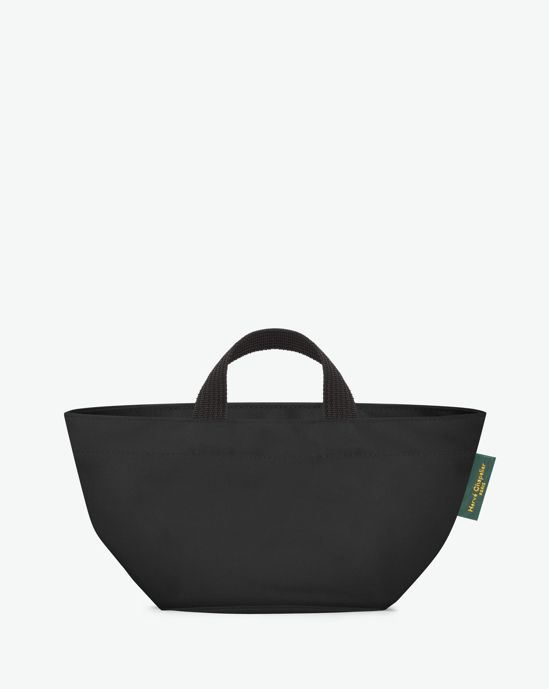 Sac à main cabas de couleur en nylon bicolore, à fond carré et dans un format S. Présence d'un double zip, de poignées courtes noires en polypropylène, et d'une étiquette de marque verte.