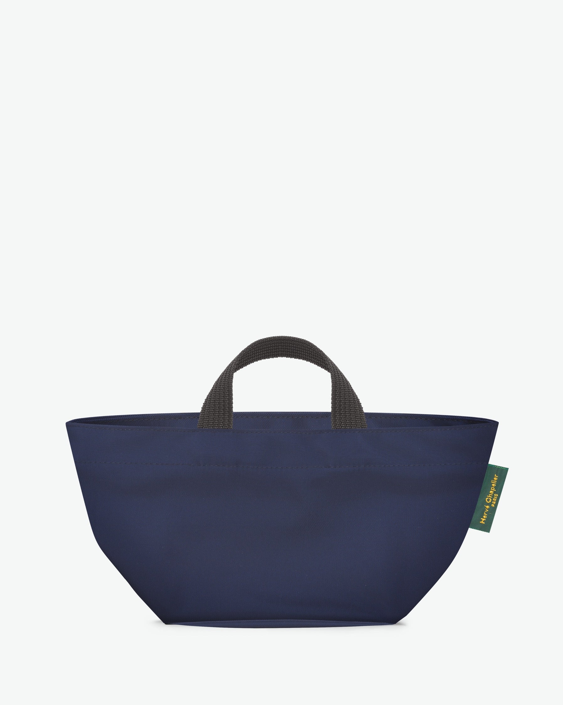 Sac à main cabas de couleur en nylon bicolore, à fond carré et dans un format S. Présence d'un double zip, de poignées courtes noires en polypropylène, et d'une étiquette de marque verte.