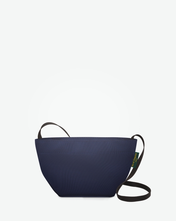 Hervé Chapelier -  - Visual on a white background of a shoulder bag standing upright and straight, with a long handle and a zip with double closure. The bag is made from nylon fabric in a dark blue color. The Hervé Chapelier label is affixed to the left-hand side.