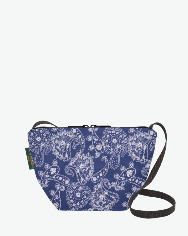 Hervé Chapelier -  - Visual on a white background of a shoulder bag standing upright and straight, with a long handle and a zip with double closure. The bag is made from printed nylon fabric in bandana bleu motif. The Hervé Chapelier label is affixed to the left-hand side.