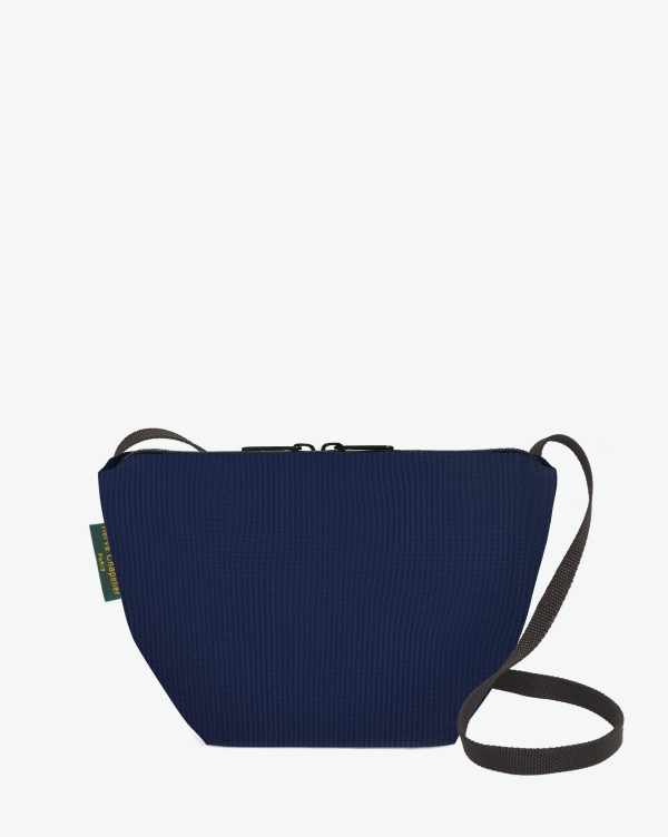 Hervé Chapelier -  - Visual on a white background of a shoulder bag standing upright and straight, with a long handle and a zip with double closure. The bag is made from printed nylon fabric in a dark blue color. The Hervé Chapelier label is affixed to the left-hand side.